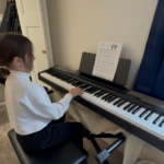 student taking piano lesson